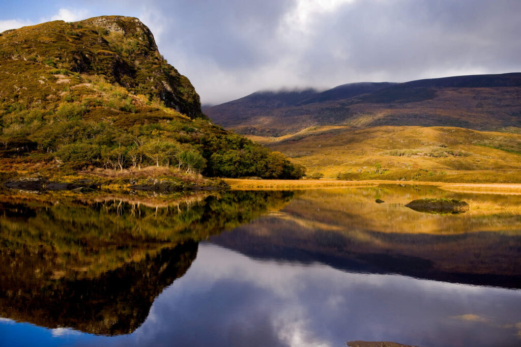 View of the eagles nest found on Lough Leane with hills reflected in the water