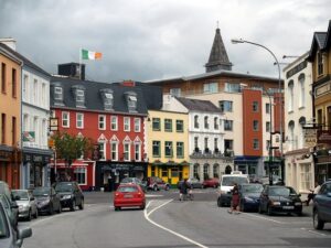 Cars driving along college street Killarney